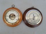 two clocks that are on the wall next to each other