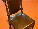 a brown chair that is sitting on a red floor