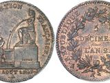 a close up of a coin with a statue on top of it