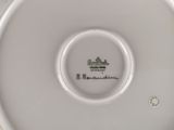 the underside of a white plate with a black and white design