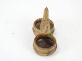 a small bird sitting on top of a wooden bowl