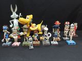 many figurines of cartoon characters on a black background