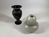 two vases sitting next to each other on a table