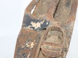 a rusted shoe that is sitting on a white surface