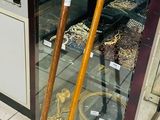 a display case with a pair of walking canes in front of it