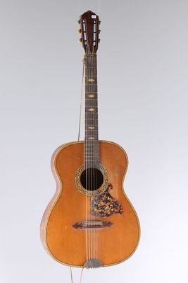 une image représentant une guitare accrochée à un mur, sur fond blanc
