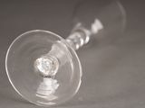 a wine glass with a diamond in it on a table