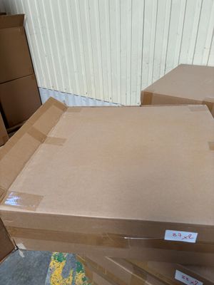 several cardboard boxes stacked on top of each other in a warehouse