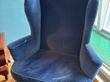 a blue chair and a blue ottoman in a living room