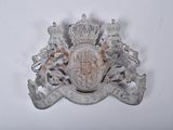 a silver and white coat of arms with a crown on top of it