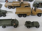 many toy army vehicles and trucks on a table