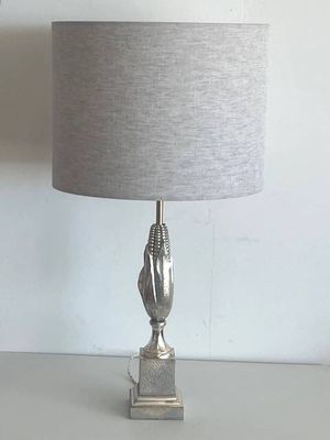 a lamp that is sitting on a table next to a wall