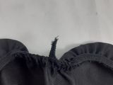 a close up of a black dress with a ruffle on it