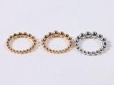 three gold and silver beaded rings on a white background