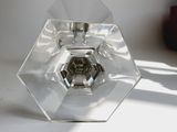 a glass candle holder sitting on a white table