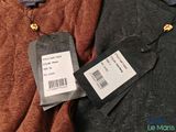 a label on a sweater that says the price of a sweater