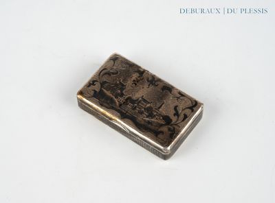a silver cigarette case sitting on a white surface