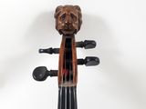 a close up of a violin with a bear head on the back