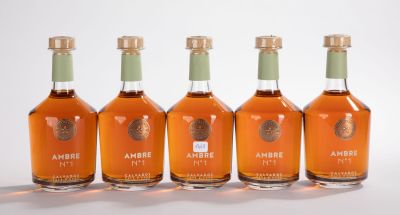 quatre bouteilles d'alcool sont alignées les unes à côté des autres sur une surface blanche