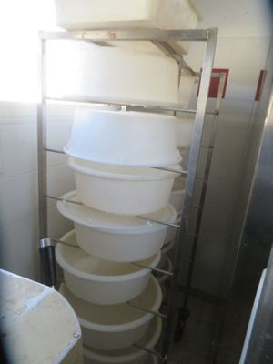 a tall stack of plastic containers in a kitchen