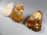 three different types of rocks on a gray surface
