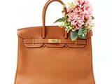 an image of a brown purse with flowers on top of it