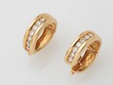 a pair of gold and diamond hoop earrings