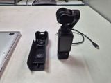 two remote controls sitting on a table next to a laptop