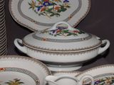 a lot of plates and bowls that are on a table
