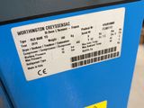 a parking meter that has a yellow sticker on it