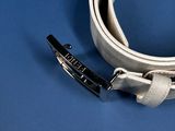 a white belt with a black buckle on a blue surface