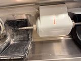 a roll of paper on a machine that has a roll of toilet paper on it