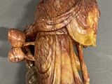 a figurine of a man with a bird on his shoulder