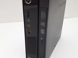 a close up of a small black computer on a white surface