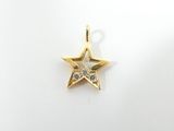 a small gold star charm with a diamond in the center
