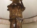 a close up of a lamp with a bird on top of it