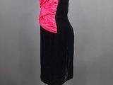 black and pink cocktail dress on a mannequin stand