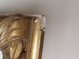 a gold frame with a picture of a woman on it