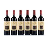 six bottles of red wine lined up in a row