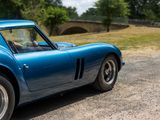 an image of a blue sports car parked on the side of the road