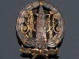 a badge with a clock tower in the middle of it
