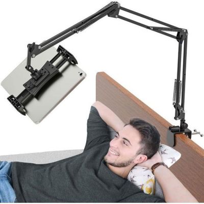 an image of a man laying on a bed with a laptop on his lap