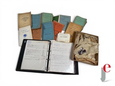 a lot of old books and papers on the table