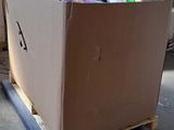 a cardboard box sitting on a pallet in a room