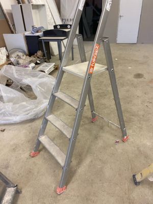 a ladder that is sitting in the middle of a room