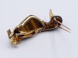 a close up of a brooch with a long blade sticking out of it