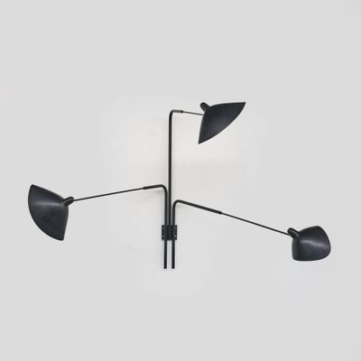 une photographie en noir et blanc représentant trois lampes accrochées à un mur