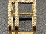 an image of a gold ring with diamonds on a black surface