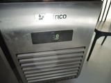a clock on the side of a refrigerator in a kitchen