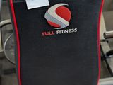 a black and red chair with a red seat in a gym